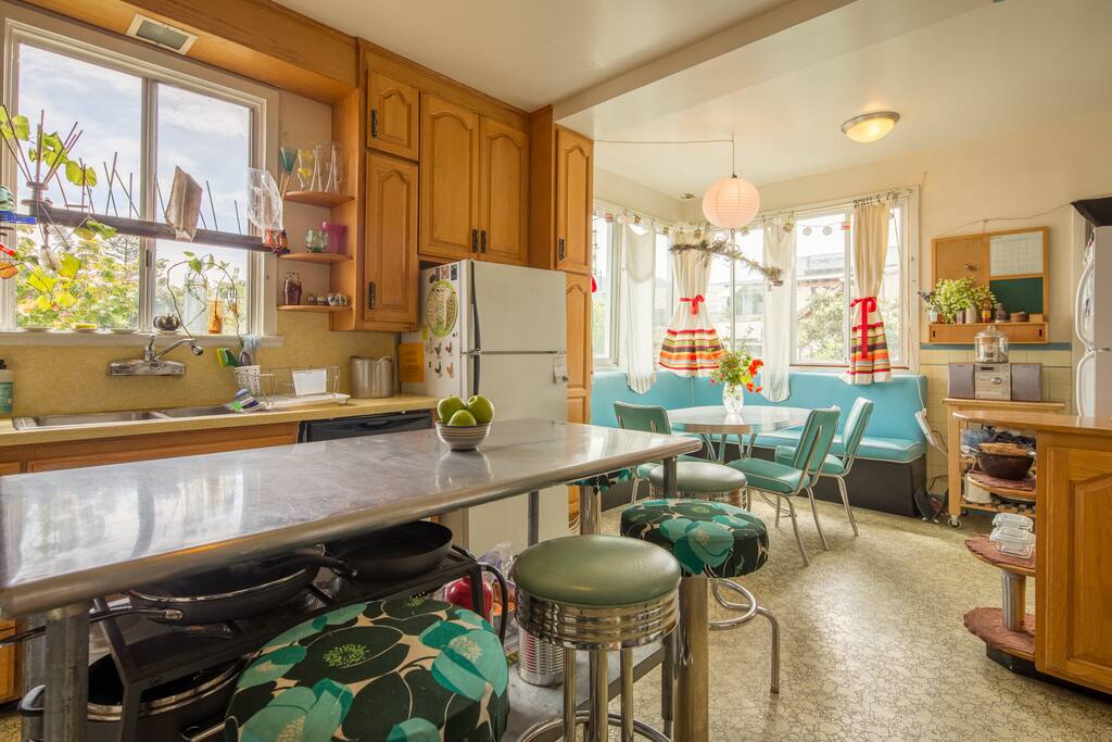 The kitchen with professional stainless steel prep surface, and breakfast nook beyond.