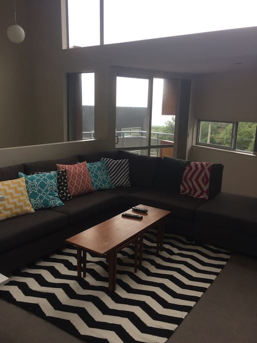 Open plan lounge with two decks - one looks over Wellington Harbour and the other to bush reserve