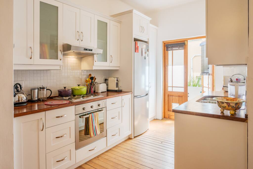 Kitchen off the dining room leading to a small sunny balcony