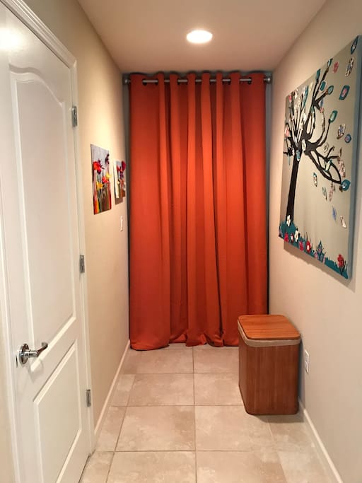 Some fun art and the closet with a stackable washer and dryer laundry soap and fabric softeners for your exclusive use.