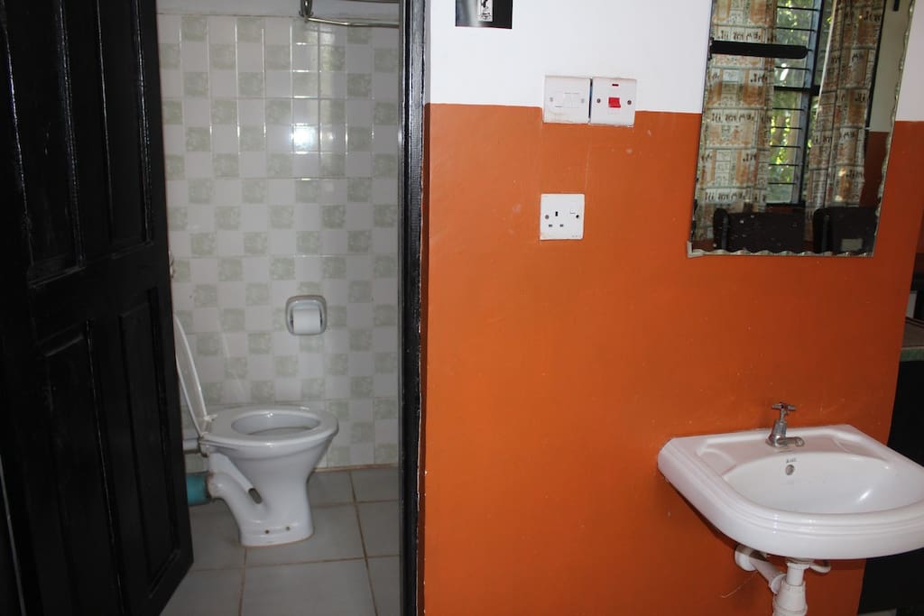 toilet and shower with sink outside bathroom