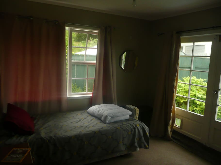 King single private room, doors open to back yard.