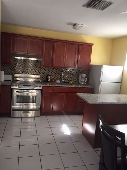 Newly remodeled kitchen with granite counter tops; fully equipped with cooking and serving items.