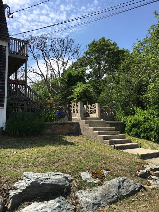 Decks and cement patio with pond view upstairs and downstairs