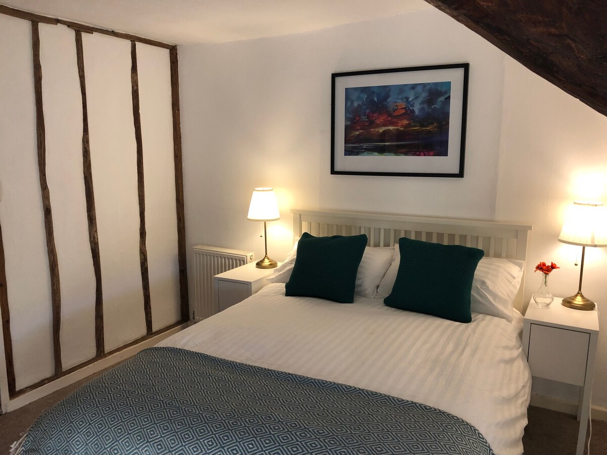 Hobbit Bedroom. Double bed, wardrobe and wash basin. Quirky bedroom full of historic features