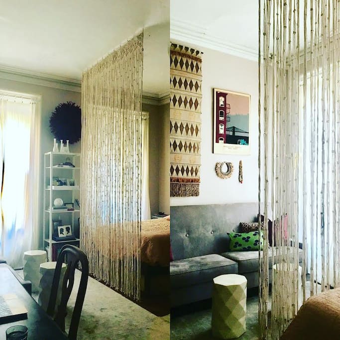 custom textile curtain that separates the living from sleeping areas.