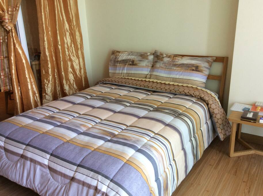 Comfortable bed with adjacent balcony