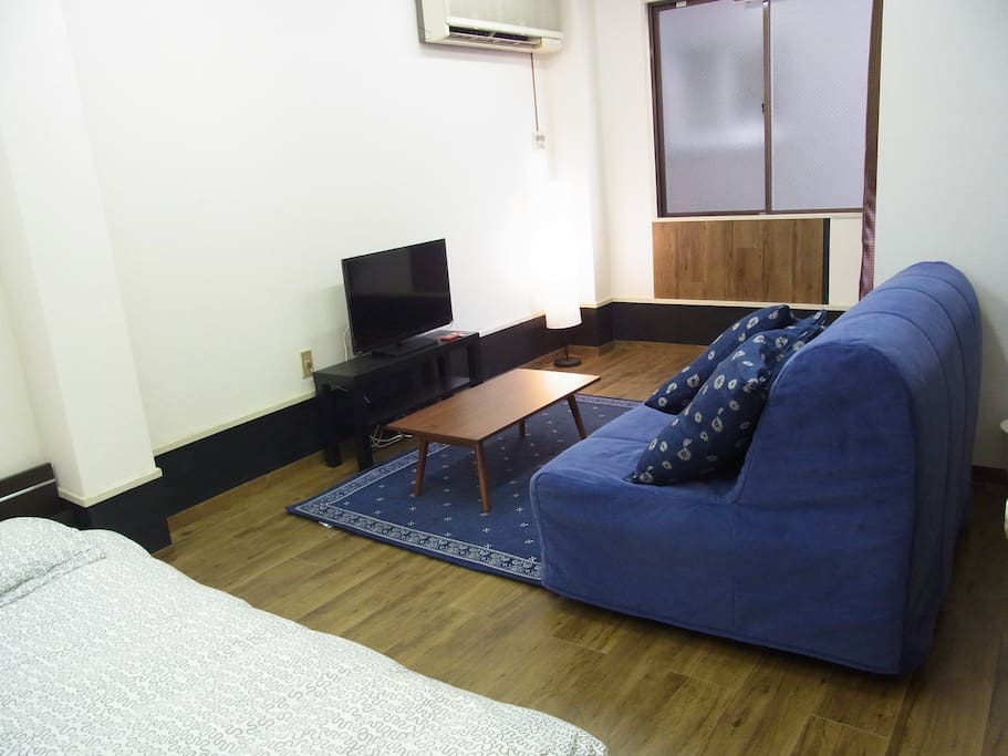 Another view of the sofabed and a table.