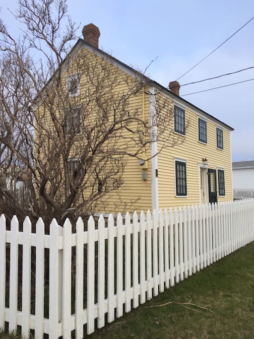 Front of house with storm windows on