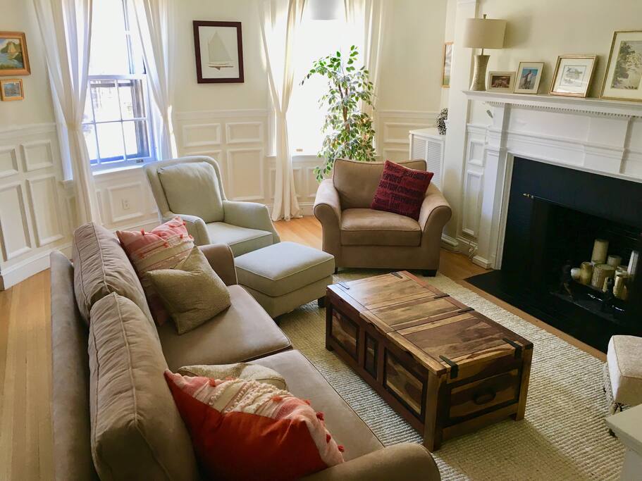 Sunshine filled living/dining room is a great place to eat a meal or rest on the over sized couch/chair after a day around Boston