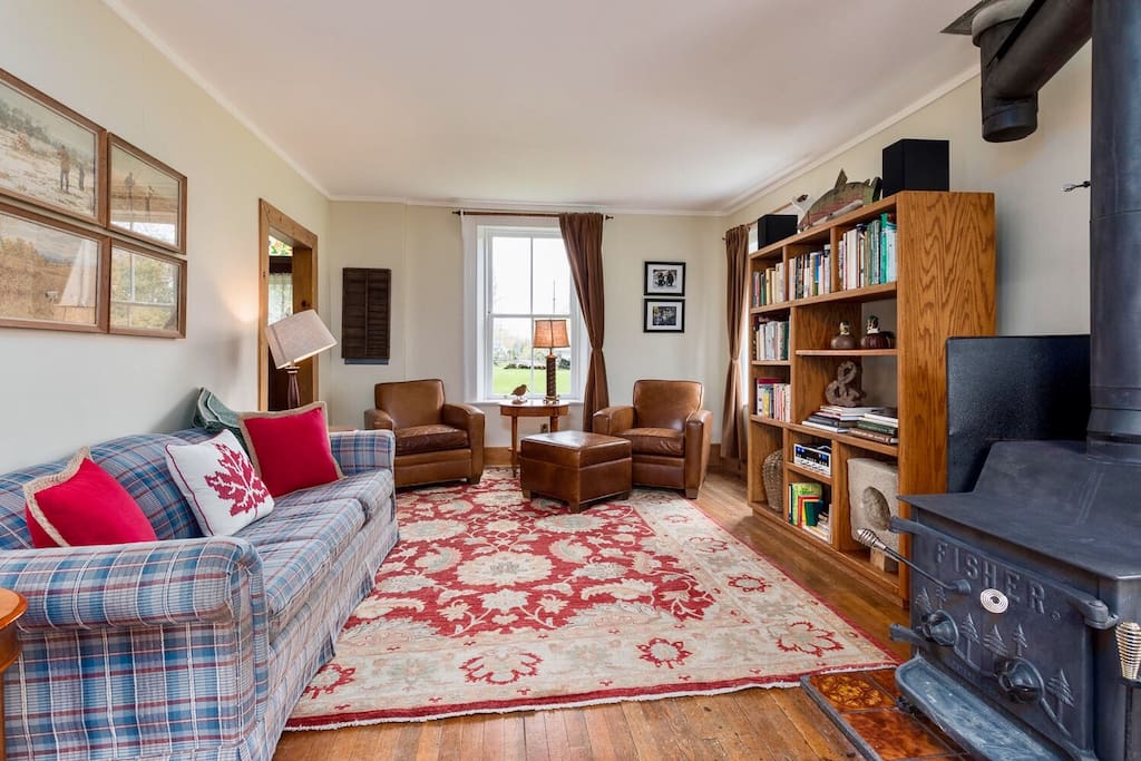The inviting living room is a perfect place to socialize by the woodstove.