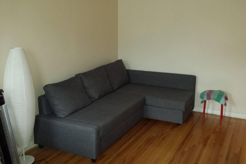 L shaped couch in living room area.