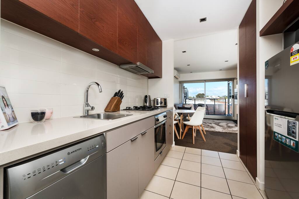 Modern fully equipped kitchen with laundry