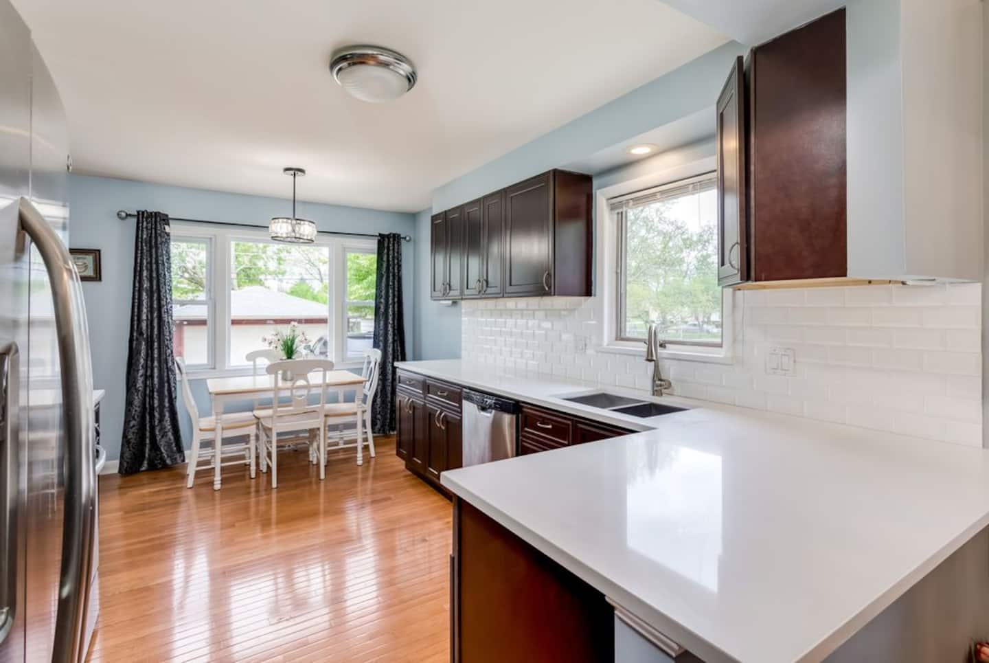 A modern kitchen with stainless steel appliances and a large island, perfect for preparing meals and gathering.