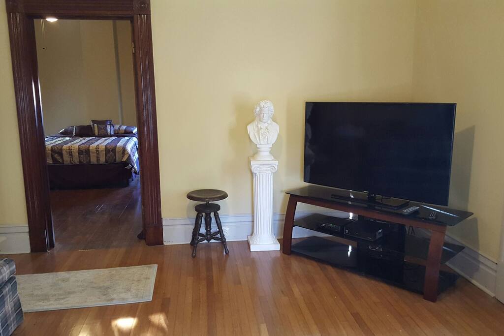 Living Room with 55" Smart TV. Front (Vellum) Bedroom is in background.