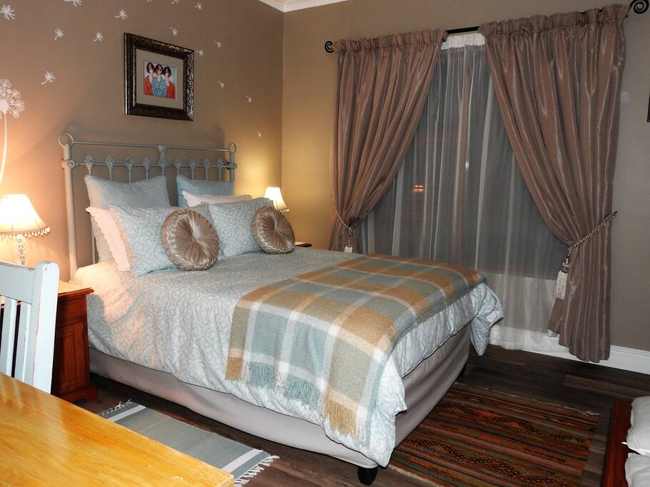 Comfortable double bed and television with all DSTV channels in the room.