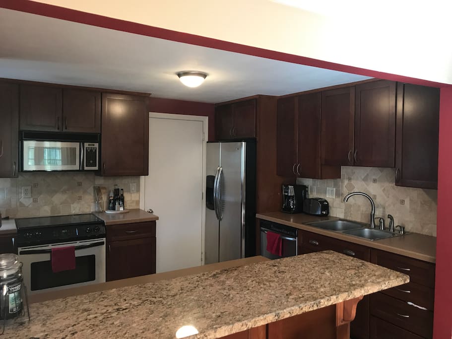 Kitchen with stainless steel appliances & breakfast bar