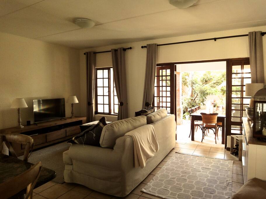 Comfortable lounge with large sofa and smart TV