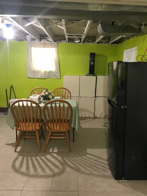 this is dining room with dining table, a refrigerator is all for you to use.