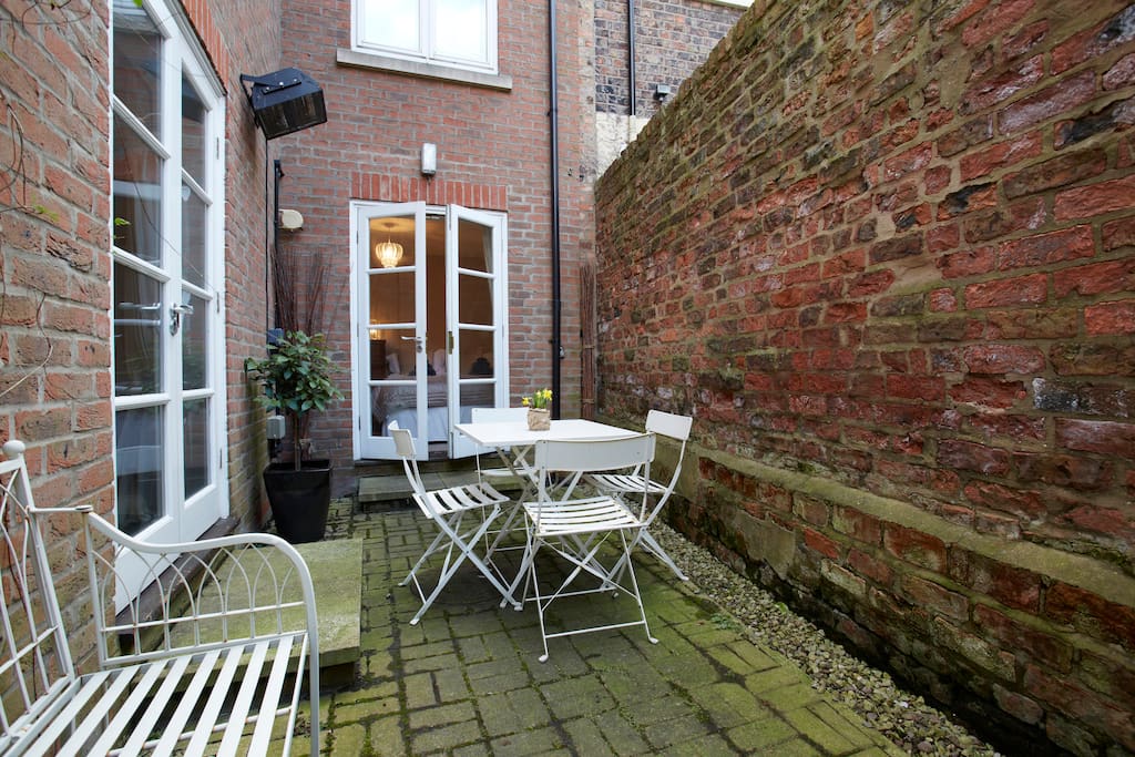 Private courtyard with seating and a heater, perfect for relaxing after a hard day enjoying the attractions of the city.