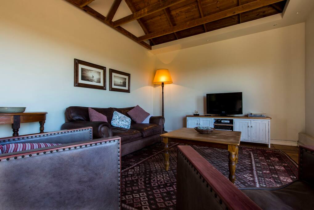 Spacious lounge with sea and garden views