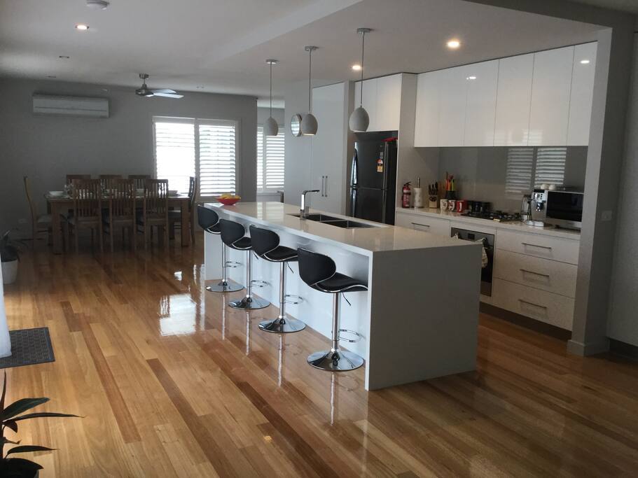 Hostess kitchen with everything you could wish for to entertain with. Large dining area, breakfast bar, & beautiful, easy care polished wooden floors.