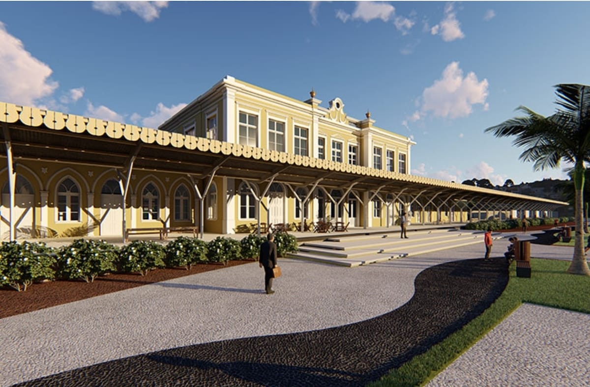 A grand building with a yellow façade and ornate architectural details is depicted. A spacious porch is visible, supported by columns and covered by an awning. Pathways lined with greenery lead up to the entrance, with people strolling along the scene.