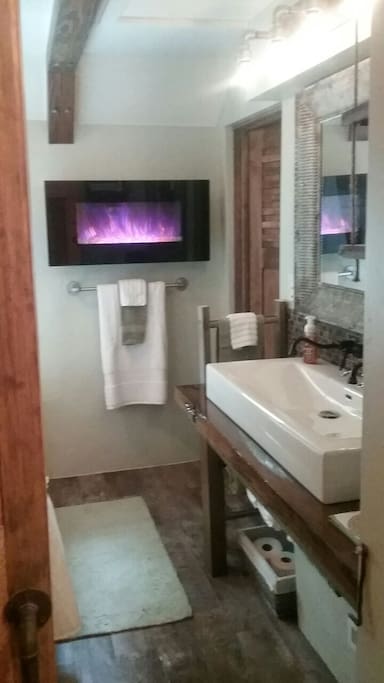 Trough sink for two with a fire place and coffee area to top it off!