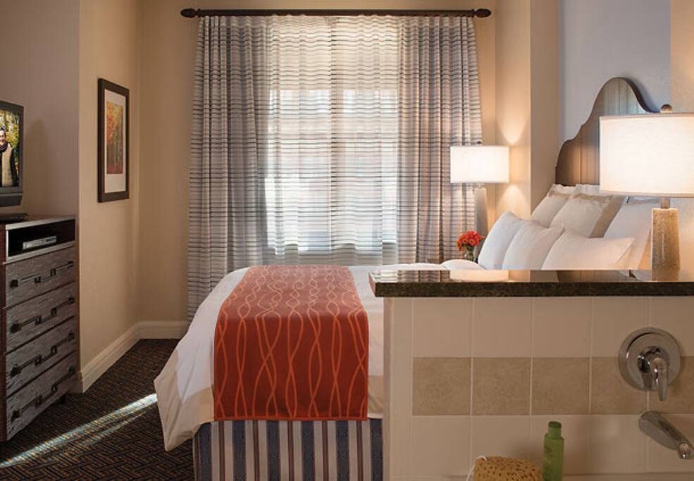 large king bedroom with jet tub and tv
