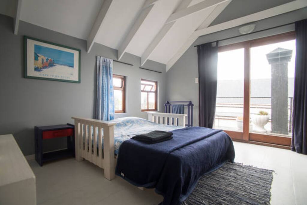 Your room with double bed, view over the lake from your bed. Wardrobe space available, not visible in this picture.