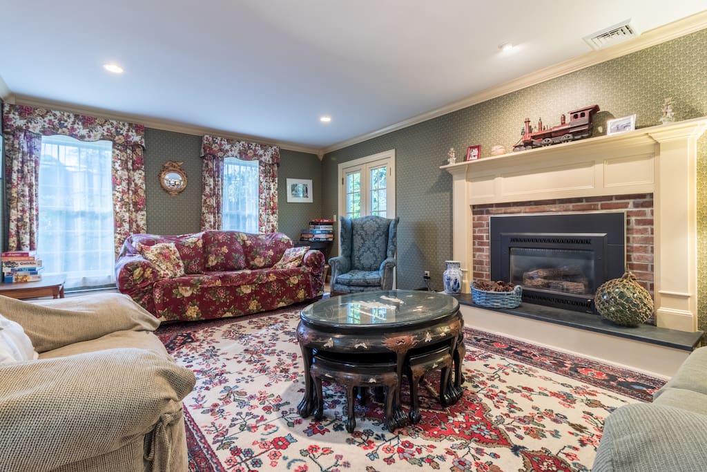 Spacious living area with a brick gas fireplace.