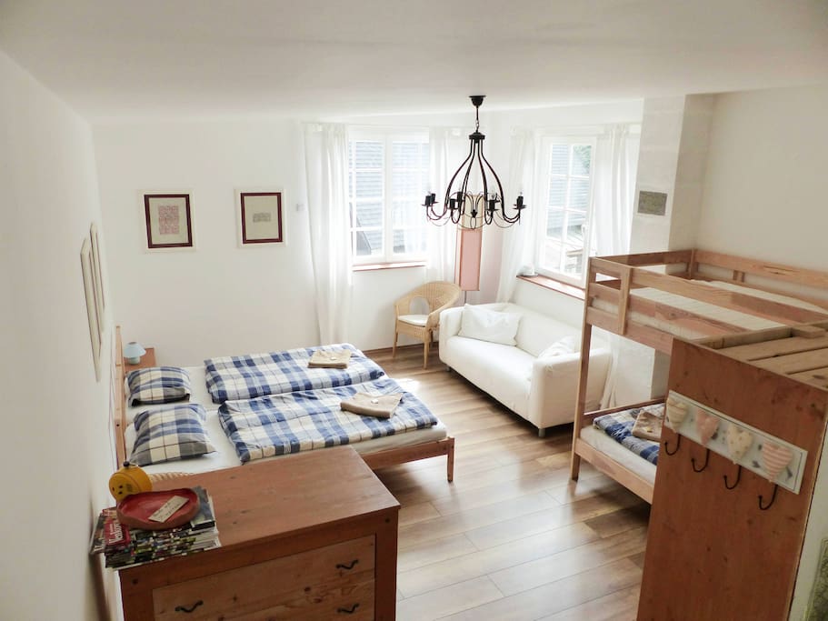 bedroom with two large windows and 4 beds