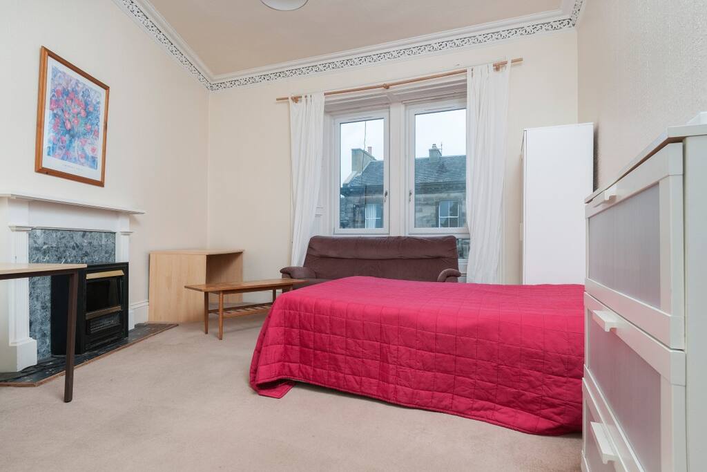 front bedroom views to Bruntsfield Links, feature fireplace and original cornicing