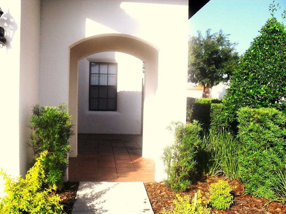 Enter the Mediterranean style front courtyard via an imposing archway.