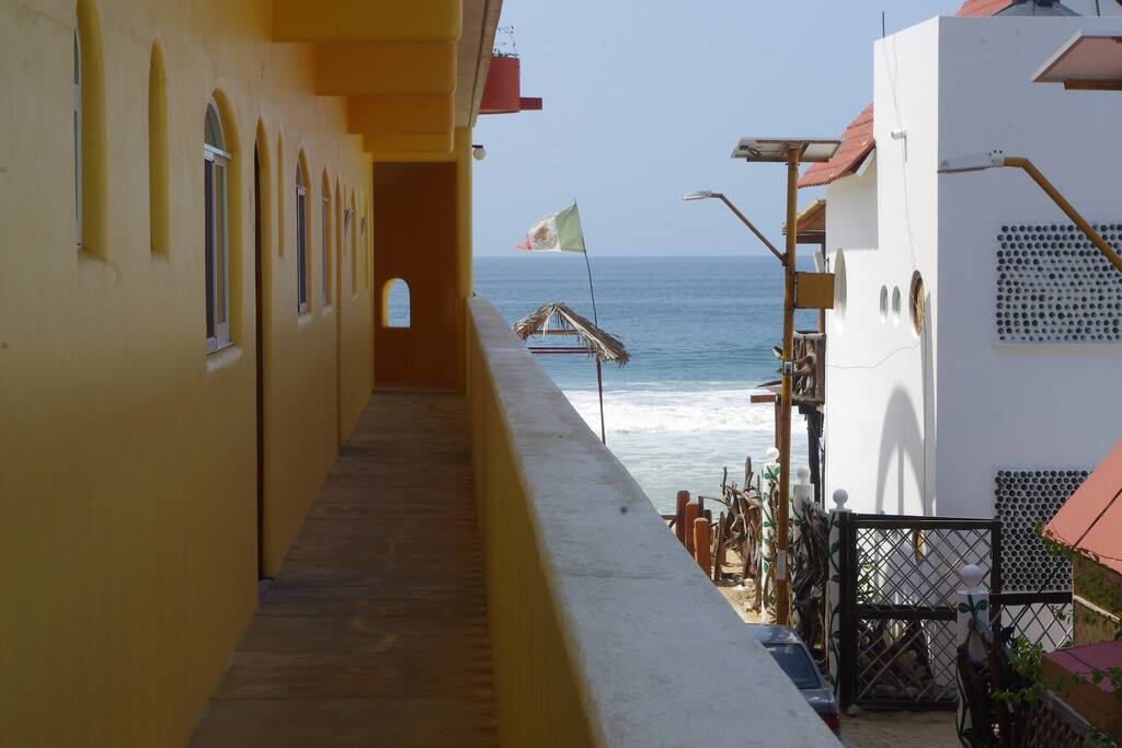 A side view of the building with a view of the ocean.