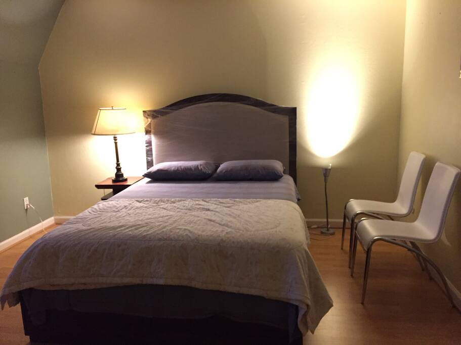 Bedroom with queen size bed and ample space for a twin floor mattress upon request