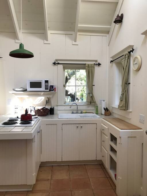 The kitchen has cooktop, microwave, coffee maker, pots and pans and other basics needed for cooking.