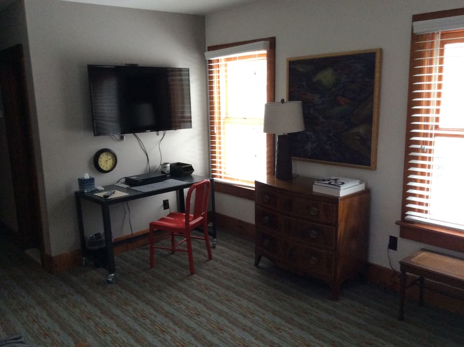 Work area with wall mounted LED TV and wifi.