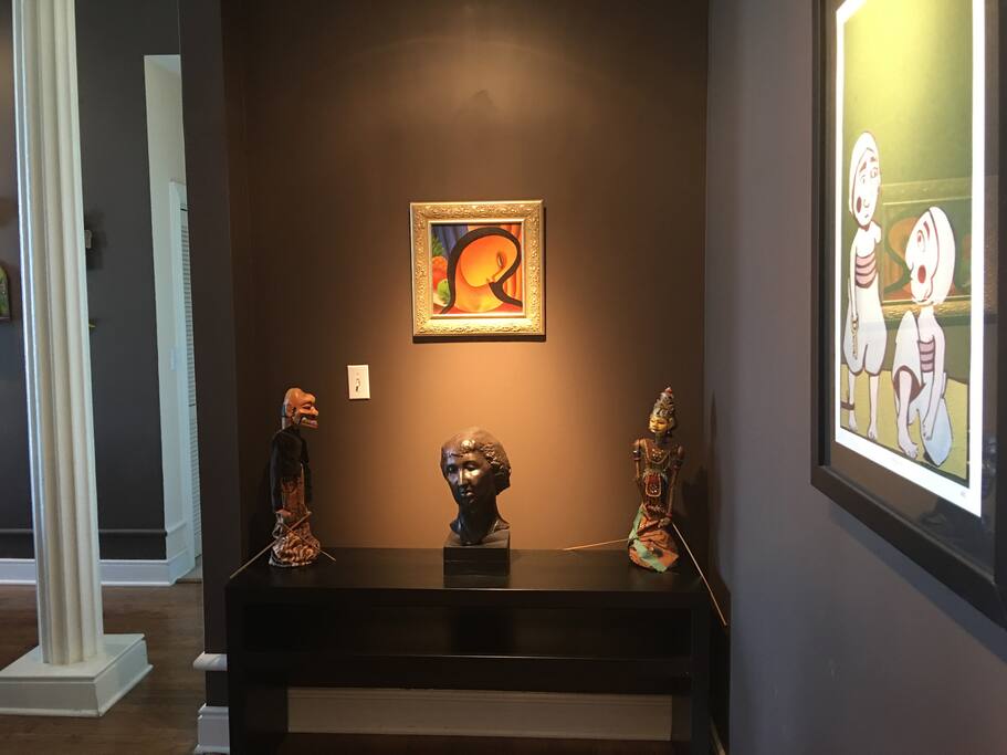 Chocolate walls contrasted with bright artwork.