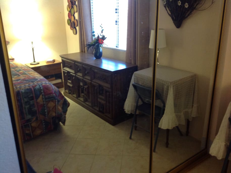 Guest bedroom with mirrored closet
