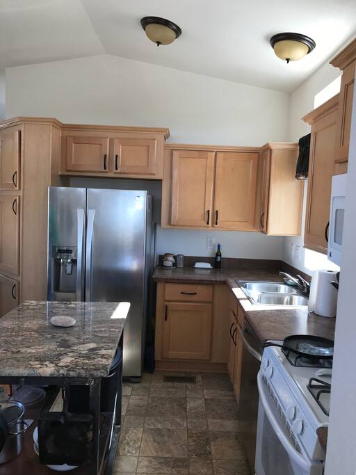 Kitchen with granite topped, movable island.