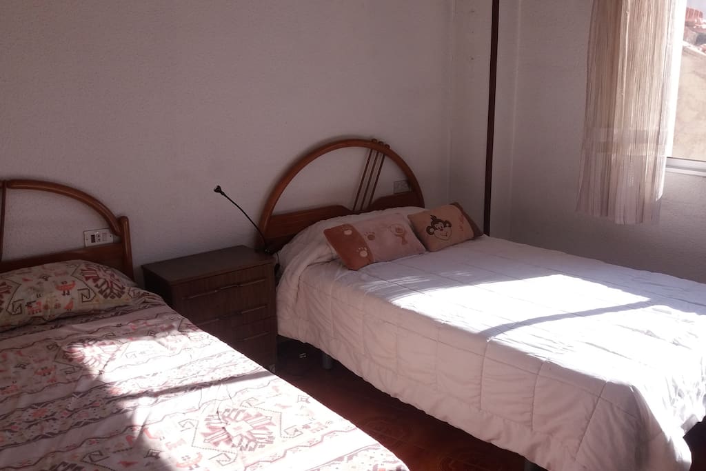 Bedroom with 2 single beds. As you can see, all the rooms have a lot of light.