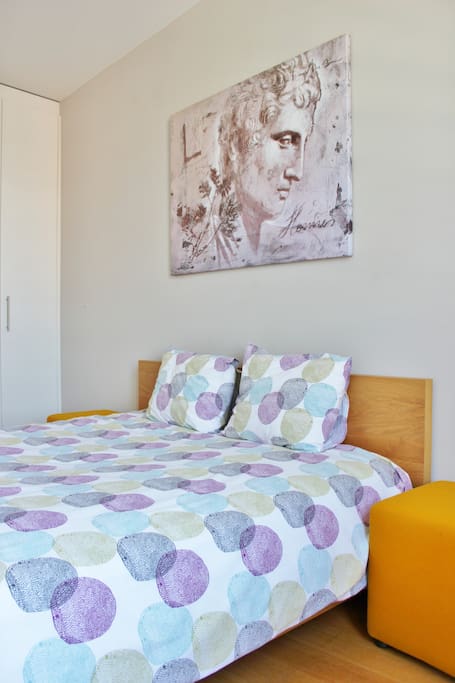 Closet and shelf space on the side of the bed, as well as at the foot of the bed.