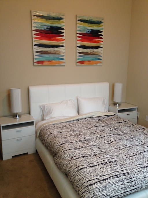 Your comfy bed. Night stands have power for your devices charging