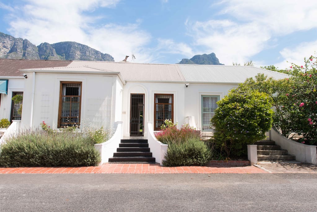 Five steps lead up to the front door. The designated brick-paved parking place is directly in front of the cottage.