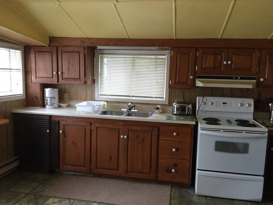 Kitchen with a modern stove and 2 refrigerators (not shown).