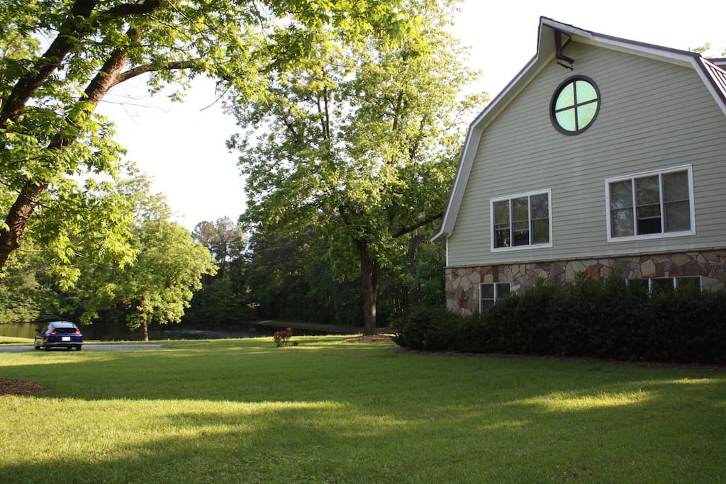 View of side of home facing towards driveway and pond.