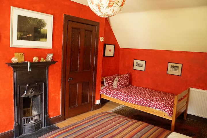 A detail of the red bedroom. The photos are of Judy's grandfather's army unit meeting the Prince of Wales at Amiens in 1918