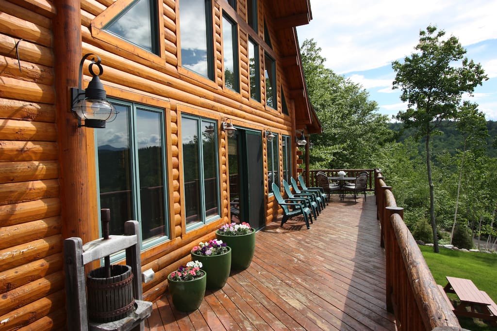 Sprawling Deck With Outside Dining And Plenty of Chairs