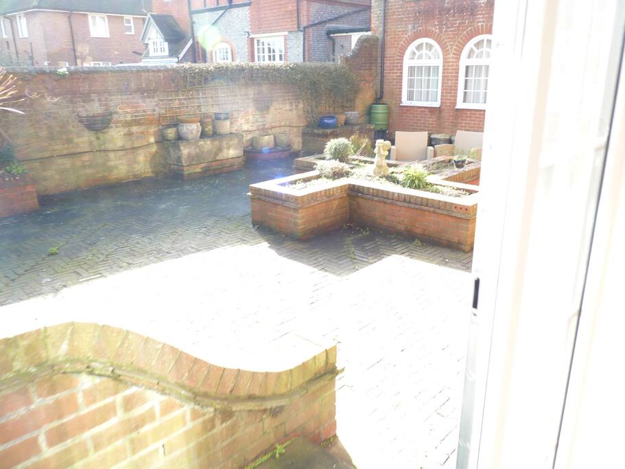 A south-facing terrace with table and chairs